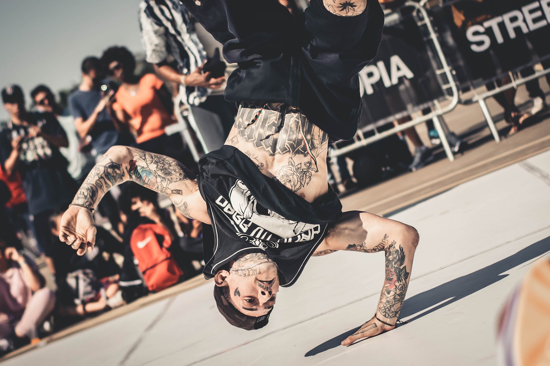 crowd watching a man doing breakdancing